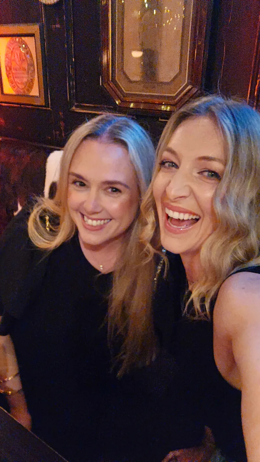 Two women smiling together indoors