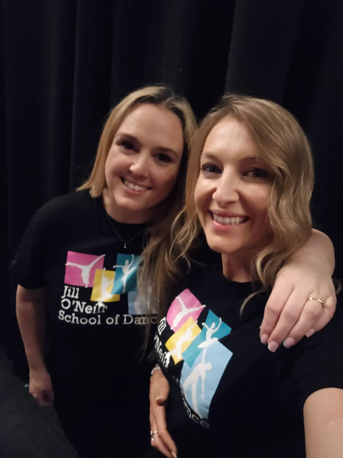 Two women in school of dance t-shirts