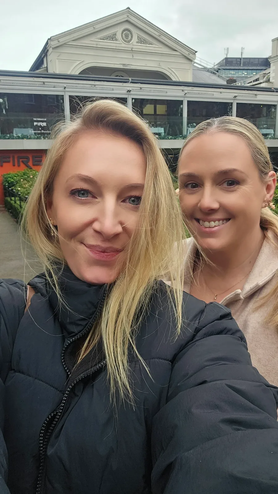 Two women standing outside a building